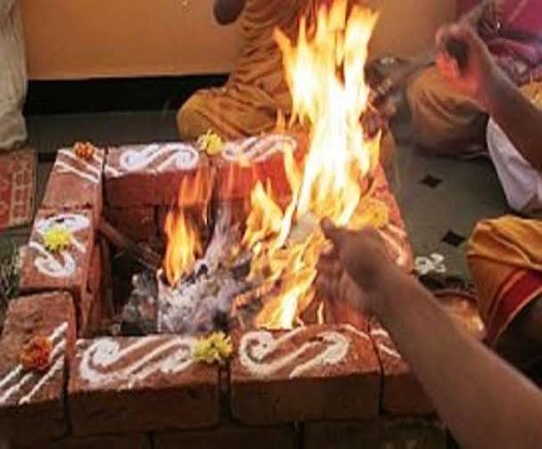 Aarti flame during a puja ceremony conducted by a pandit in Bangalore